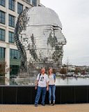 Alison and Steve with the Big Head  Metalmorphosis is a mirrored water fountain by Czech sculptor David Černý that was constructed at the Whitehall Technology Park in Charlotte, NC. The 14-ton sculpture is made from massive stainless steel layers that rotate 360 degrees and occasionally align to create a massive head. It even has it’s own live webcam.   3701 Arco Corporate Dr Charlotte, NC 28273 : Alison, Big Head, Charlotte, Metalmorphosis, Steve